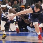 
              Dallas Mavericks guard Luka Doncic, right, and Minnesota Timberwolves guard Patrick Beverley, left, chase the ball during the second half of an NBA basketball game in Dallas, Monday, March 21, 2022. (AP Photo/LM Otero)
            