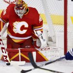 
              Calgary Flames goalie Jacob Markstrom, left, makes a save as Tampa Bay Lightning's Ondrej Palat looks for a rebound during the first period of an NHL hockey game Thursday, March 10, 2022, in Calgary, Alberta. (Larry MacDougal/The Canadian Press via AP)
            