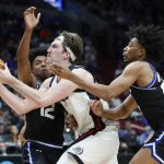 
              Gonzaga forward Drew Timme, center, drives between Georgia State guard Kane Williams (12) and guard Collin Moore, right, during the second half of a first round NCAA college basketball tournament game, Thursday, March 17, 2022, in Portland, Ore. (AP Photo/Craig Mitchelldyer)
            
