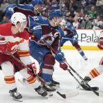 
              Colorado Avalanche left wing Gabriel Landeskog, center, drives between Calgary Flames left wing Matthew Tkachuk, left, and defenseman Oliver Kylington to score a goal during the first period of an NHL hockey game Saturday, March 5, 2022, in Denver. (AP Photo/David Zalubowski)
            