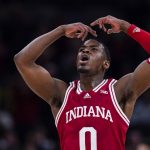 
              Indiana guard Xavier Johnson (0) celebrates as Indiana takes the lead over Michigan in the second half of an NCAA college basketball game at the Big Ten Conference tournament in Indianapolis, Thursday, March 10, 2022. Indiana defeated Michigan 74-69. (AP Photo/Michael Conroy)
            