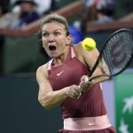 
              Simona Halep, of Romania, returns a shot to Iga Swiatek, of Poland, during the women's singles semifinals at the BNP Paribas Open tennis tournament Friday, March 18, 2022, in Indian Wells, Calif. (AP Photo/Mark J. Terrill)
            
