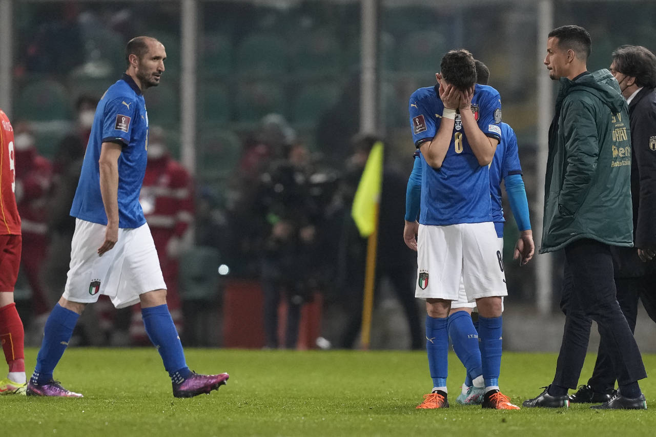 Italy's Jorginho, right, cries as his teammate walks after their team's got eliminated in the World...