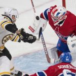 
              Boston Bruins' Brad Marchand (63) is stopped by Montreal Canadiens goaltender Jake Allen (34) during first-period NHL hockey game action in Montreal, Monday, March 21, 2022. (Ryan Remiorz/The Canadian Press via AP)
            