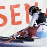 
              Switzerland's Lara Gut Behrami sits on the snow after crossing the finish line of an alpine ski, women's World Cup super-G, in Lenzerheide, Switzerland, Saturday, March 5, 2022. (AP Photo/Giovanni Auletta)
            