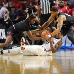 
              Auburn guard K.D. Johnson, center, battles for a loose ball between Jacksonville State forward Kayne Henry, left, and guard Darian Adams during the first half of a college basketball game in the first round of the NCAA tournament on Friday, March 18, 2022, in Greenville, S.C. (AP Photo/Chris Carlson)
            