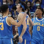 
              UCLA guard Jaime Jaquez Jr., center, celebrates as time runs out with guard Johnny Juzang, left, and guard Jaylen Clark in second half of an NCAA college basketball game against Southern California Saturday, March 5, 2022, in Los Angeles. UCLA won 75-68. (AP Photo/Mark J. Terrill)
            