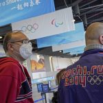 
              A Russian new agency journalist wearing the Sochi Winter Olympic jacket as he line up with his colleague outside a store selling official Olympics memorabilia ahead of the 2022 Winter Paralympics at the Main Media Center in Beijing, China, Wednesday, March 2, 2022. Russian and Belarusian athletes at the Winter Paralympic Games in Beijing will compete as “neutrals,” but will not be expelled because of their countries' roles in the war against Ukraine, the International Paralympic Committee said Wednesday. (AP Photo/Andy Wong)
            