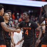 
              Miami guard Jordan Miller, left, guard Bensley Joseph (4) and forward Deng Gak (22) celebrate their win against Syracuse after an NCAA college basketball game in Syracuse, N.Y., Saturday, March 5, 2022. (AP Photo/Adrian Kraus)
            