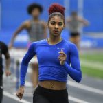 
              Kentucky track & field athlete Masai Russell runs during practice at Nutter Field House in Lexington, Ky., Friday, Feb. 18, 2022. Russell is among a cohort of NCAA women's athletes who are making a name for themselves on social media. (AP Photo/Timothy D. Easley)
            