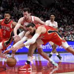 
              New Orleans Pelicans guard CJ McCollum, left, and Portland Trail Blazers forward Drew Eubanks, center, and center Jonas Valanciunas, right, go after the ball during the first half of an NBA basketball game in Portland, Ore., Wednesday, March 30, 2022. (AP Photo/Steve Dykes)
            