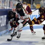 
              Ohio State's Lexi Templeman (22) and Sara Saekkinen (25) battle for the puck with Minnesota-Duluth's Brenna Fuhrman (20) during the first period of the NCAA Frozen Four championship hockey game, Sunday, March 20, 2022, in State College, Pa. (AP Photo/Gary M. Baranec)
            