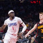 
              Los Angeles Clippers guard Reggie Jackson (1) dribbles past Atlanta Hawks guard Kevin Huerter (3) during the first half of an NBA basketball game Friday, March 11, 2022, in Atlanta. (AP Photo/Hakim Wright Sr.)
            