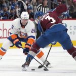 
              New York Islanders center Brock Nelson, left, and Colorado Avalanche defenseman Jack Johnson try to get control of the puck during the second period of an NHL hockey game Tuesday, March 1, 2022, in Denver. (AP Photo/David Zalubowski)
            