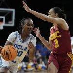 
              UCLA's Charisma Osborne (20) drives into Southern California's Tera Reed (3) during the first half of an NCAA college basketball game in the first round of the Pac-12 women's tournament Wednesday, March 2, 2022, in Las Vegas. (AP Photo/John Locher)
            