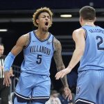 
              Villanova's Justin Moore (5) reacts with Collin Gillespie (2) during the first half of an NCAA college basketball game against Butler, Saturday, March 5, 2022, in Indianapolis. (AP Photo/Darron Cummings)
            