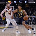 
              Indiana Pacers guard Malcolm Brogdon (7) drives on Cleveland Cavaliers forward Dean Wade (32) during the second half of an NBA basketball game in Indianapolis, Tuesday, March 8, 2022. The Cavaliers won 127-124. (AP Photo/Michael Conroy)
            
