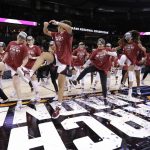 
              Stanford head coach Tara VanDerveer center, joins her players in a dance behind the regional trophy after they beat Texas 59-50 in a college basketball game in the Elite 8 round of the NCAA tournament, Sunday, March 27, 2022, in Spokane, Wash. (AP Photo/Young Kwak)
            