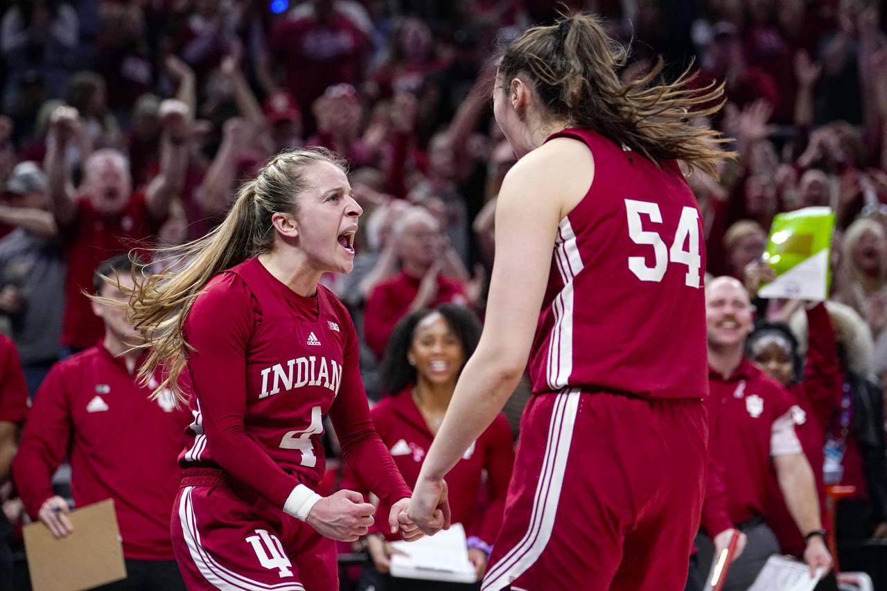 Indiana guard Nicole Cardano-Hillary (4) celebrates with forward Mackenzie Holmes (54) after being ...