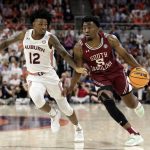 
              South Carolina guard Jermaine Couisnard (5) dribbles around Auburn guard Zep Jasper (12) as he goes to the basket during the first half of an NCAA college basketball game Saturday, March 5, 2022, in Auburn, Ala. (AP Photo/Butch Dill)
            