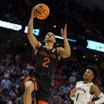 
              Miami guard Isaiah Wong (2) shoots and scores against Auburn during the second half of a college basketball game in the second round of the NCAA tournament Sunday, March 20, 2022, in Greenville, S.C. (AP Photo/Brynn Anderson)
            