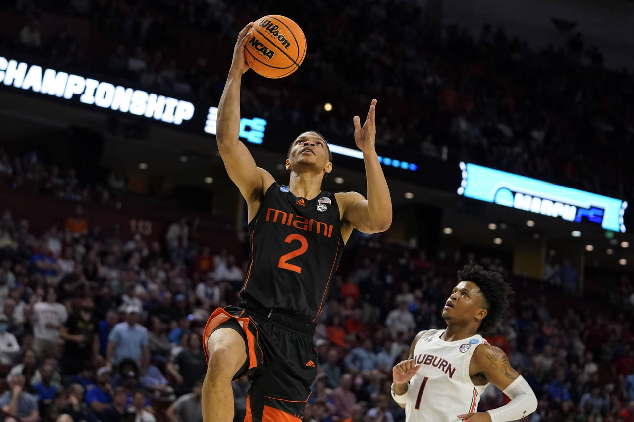 Miami guard Isaiah Wong (2) shoots and scores against Auburn during the second half of a college ba...