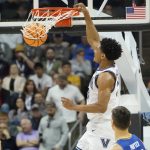 
              Villanova's Jermaine Samuels, top, dunks past Delaware's Dylan Painter during the first half of a college basketball game in the first round of the NCAA tournament, Friday, March 18, 2022, in Pittsburgh. (AP Photo/Keith Srakocic)
            