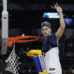 
              Villanova guard Collin Gillespie cuts the net after after their win against Houston during a college basketball game in the Elite Eight round of the NCAA tournament on Saturday, March 26, 2022, in San Antonio. (AP Photo/David J. Phillip)
            