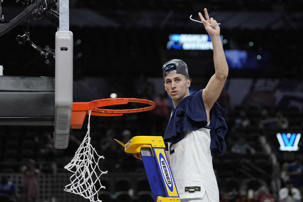 Villanova guard Collin Gillespie cuts the net after after their win against Houston during a colleg...