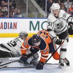 
              Los Angeles Kings goalie Jonathan Quick (32) makes a save as teammate Troy Stecher (51) checks Edmonton Oilers' Kailer Yamamoto (56) during the second period of an NHL hockey game Wednesday, March 30, 2022, in Edmonton, Alberta. (Jason Franson/The Canadian Press via AP)
            