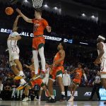 
              Miami forward Sam Waardenburg (21) blocks a shot by Southern California guard Boogie Ellis during the first half of a college basketball game in the first round of the NCAA tournament on Friday, March 18, 2022, in Greenville, S.C. (AP Photo/Chris Carlson)
            