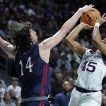 
              Gonzaga's Rasir Bolton (45) shoots over Saint Mary's Kyle Bowen (14) during the first half of an NCAA college basketball championship game at the West Coast Conference tournament Tuesday, March 8, 2022, in Las Vegas. (AP Photo/John Locher)
            