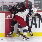 
              Columbus Blue Jackets right wing Yegor Chinakhov (59) knocks Ottawa Senators center Josh Norris off the puck during the first period of an NHL hockey game Wednesday, March 16, 2022 in Ottawa, Ontario.(Adrian Wyld/The Canadian Press via AP)
            
