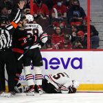 
              Chicago Blackhawks defenseman Connor Murphy (5) lies on the ice after being hit into the boards by Ottawa Senators left wing Parker Kelly (45),  during the first period of an NHL hockey game Saturday, March 12, 2022 in Ottawa, Ontario.(Justin Tang/The Canadian Press via AP)
            