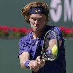 
              Andrey Rublev, of Russia, returns a shot to Grigor Dimitrov, of Bulgaria, at the BNP Paribas Open tennis tournament Friday, March 18, 2022, in Indian Wells, Calif. (AP Photo/Mark J. Terrill)
            
