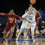 
              Southern California's Rayah Marshall (13) and UCLA's Angela Dugalic (32) vie for the ball during the first half of an NCAA college basketball game in the first round of the Pac-12 women's tournament Wednesday, March 2, 2022, in Las Vegas. (AP Photo/John Locher)
            