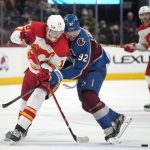 
              Colorado Avalanche left wing Gabriel Landeskog, right, pushes Calgary Flames left wing Matthew Tkachuk away from the puck during the second period of an NHL hockey game Saturday, March 5, 2022, in Denver. (AP Photo/David Zalubowski)
            