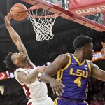 
              Arkansas guard Au'Diese Toney (5) is fouled as he tries to drive past LSU forward Darius Days (4) during the first half of an NCAA college basketball game Wednesday, March 2, 2022, in Fayetteville, Ark. (AP Photo/Michael Woods)
            