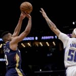 
              New Orleans Pelicans guard CJ McCollum (3) shoots over Orlando Magic guard Cole Anthony (50) during the first quarter of an NBA basketball game in New Orleans, Wednesday, March 9, 2022. (AP Photo/Derick Hingle)
            