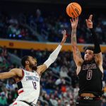 
              New Mexico State guard Teddy Allen (0) shoots against Connecticut forward Tyler Polley (12) during the second half of a college basketball game in the first round of the NCAA men's tournament Thursday, March 17, 2022, in Buffalo, N.Y. (AP Photo/Frank Franklin II)
            