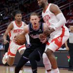 
              Sacramento Kings guard Donte DiVincenzo, middle, collides with Houston Rockets forward Bruno Fernando, right, as Jalen Green, left, watches during the first half of an NBA basketball game Wednesday, March 30, 2022, in Houston. (AP Photo/Michael Wyke)
            