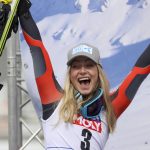 
              Norway's Ragnhild Mowinckel celebrates on the podium after winning an alpine ski, women's World Cup Finals super-G, in Courchevel, France, Thursday, March 17, 2022. (AP Photo/Alessandro Trovati)
            