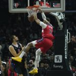 
              Washington Wizards center Daniel Gafford (21) dunks during the first half of an NBA basketball game against the LA Clippers in Los Angeles, Wednesday, March 9, 2022. (AP Photo/Ashley Landis)
            