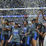 
              Kentucky head coach Kyra Elzy, right, celebrates with her players after Kentucky beat South Carolina to win the NCAA women's college basketball Southeastern Conference tournament championship game Sunday, March 6, 2022, in Nashville, Tenn. (AP Photo/Mark Humphrey)
            