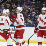 
              Carolina Hurricanes' Martin Necas (88) celebrates with Carolina Hurricanes' Ian Cole (28) and Carolina Hurricanes' Jaccob Slavin (74) after scoring a goal during the first period of an NHL hockey game against the St. Louis Blues on Saturday, March 26, 2022 in St. Louis. (AP Photo/Michael Thomas)
            
