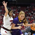 
              Albany guard Grace Heeps (14) tries to get past Louisville guard Chelsie Hall (23) during the first half of their women's NCAA Tournament college basketball first round game in Louisville, Ky., Friday, March 18, 2022. (AP Photo/Timothy D. Easley)
            