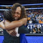 
              Kentucky head coach Kyra Elzy, right, hugs associate head coach Niya Butts after Kentucky beat Tennessee in an NCAA college basketball semifinal round game at the women's Southeastern Conference tournament Saturday, March 5, 2022, in Nashville, Tenn. (AP Photo/Mark Humphrey)
            