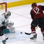 
              Arizona Coyotes' Nick Richie (12) bounces the puck off the pads of San Jose Sharks goalie Jame Reimer (47) during the second period of an NHL hockey game Wednesday, March 30, 2022, in Glendale, Ariz. (AP Photo/Darryl Webb)
            