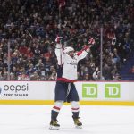 
              Washington Capitals' Alex Ovechkin celebrates Evgeny Kuznetsov's third goal against the Vancouver Canucks, during the third period of an NHL hockey game Friday, March 11, 2022, in Vancouver, British Columbia. (Darryl Dyck/The Canadian Press via AP)
            
