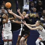 
              Connecticut's Christyn Williams, left, Olivia Nelson-Ododa, back center, and Paige Bueckers, right, reach for a rebound against Mercer's Allie Thayne, center, during the first half of a first-round women's college basketball game in the NCAA tournament, Saturday, March 19, 2022, in Storrs, Conn. (AP Photo/Jessica Hill)
            
